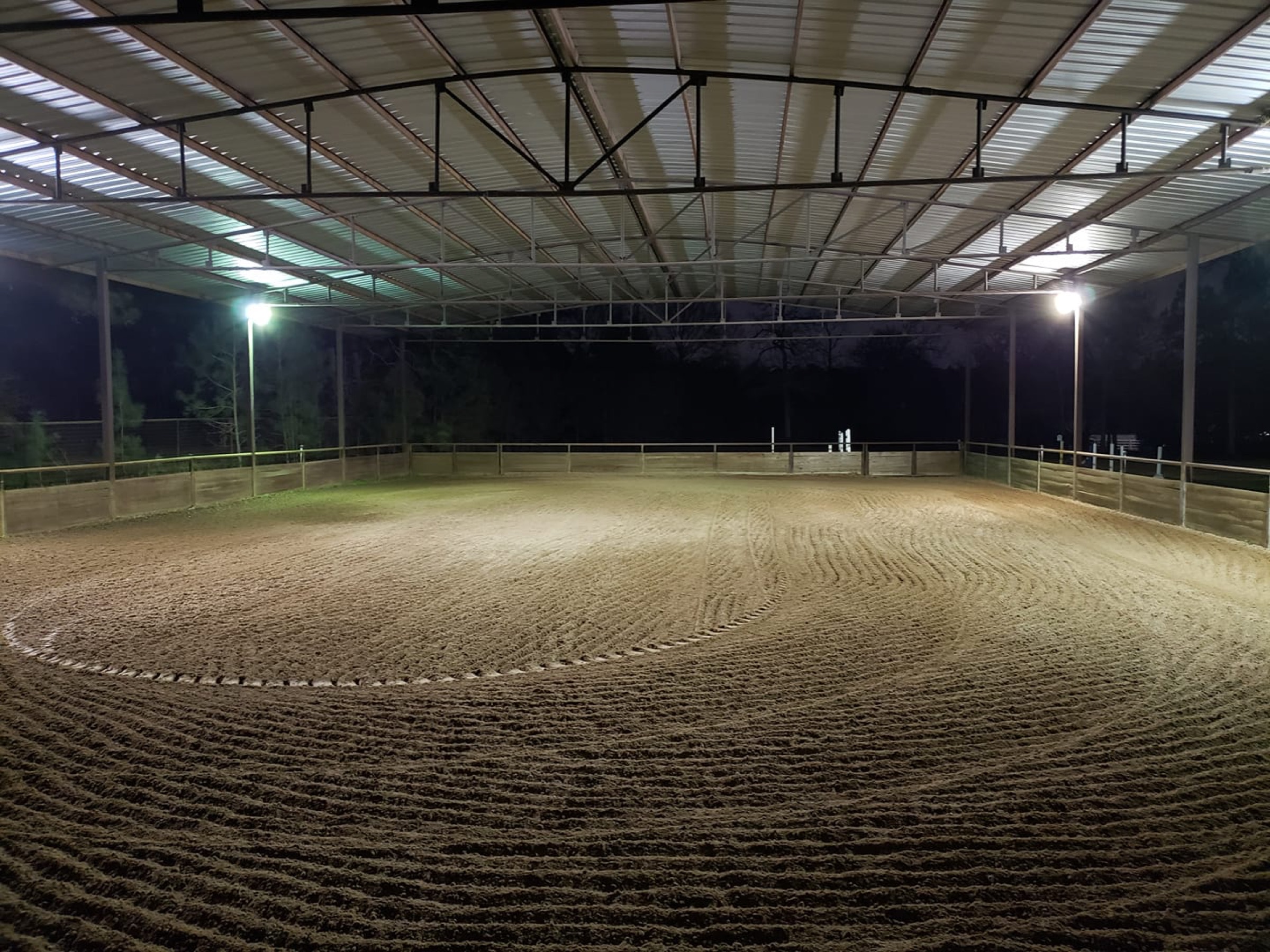Covered riding arena at Firecreek Stables lit at night